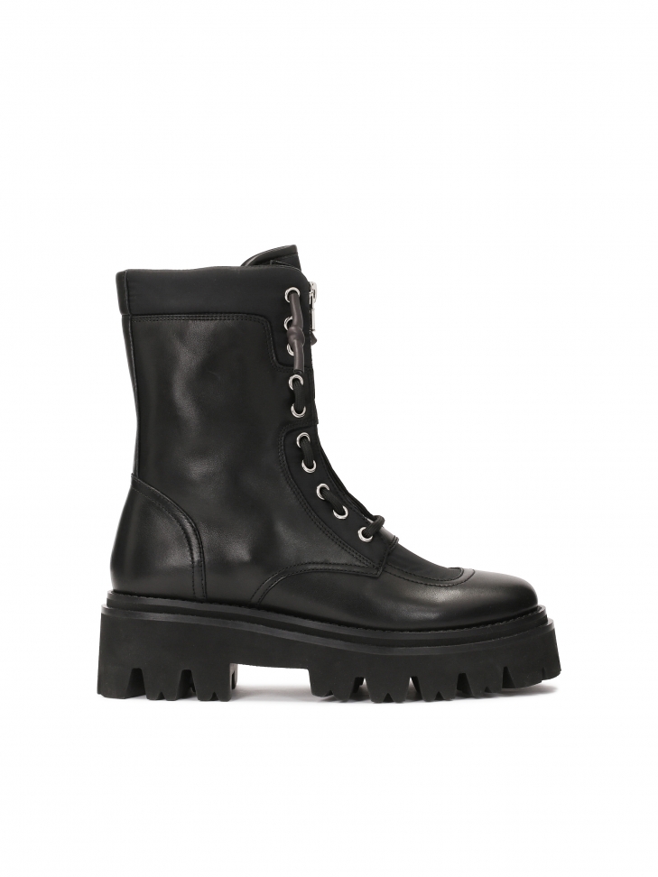 Black boots with a high upper on a trefoil sole