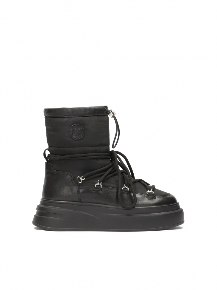 Black snow boots with binding on a thick sole