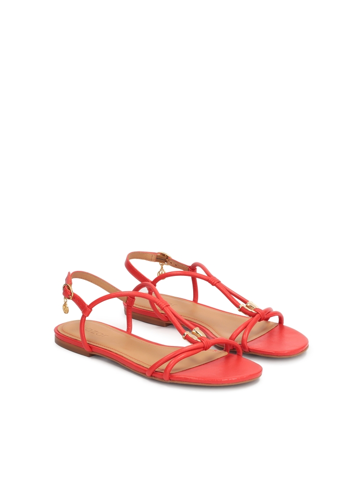 Red sandals on a flat sole with an overhang