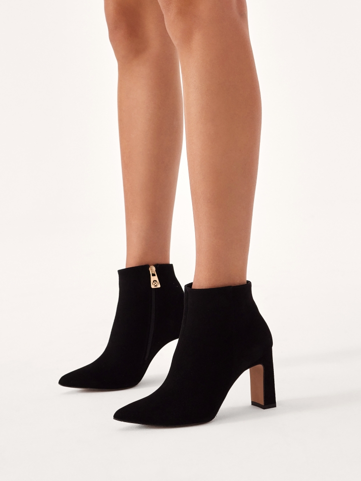Black pointed-toe boots in soft suede