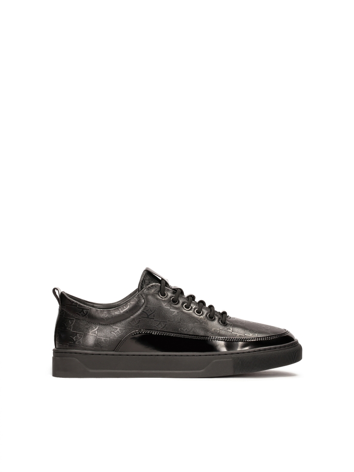 Black sneakers with embossed pattern