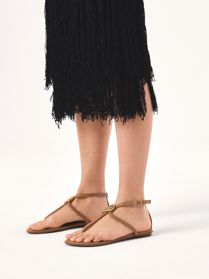 Light brown monogrammed flip flop sandals