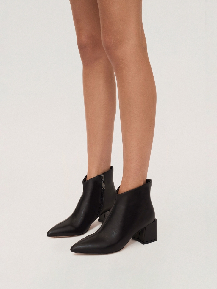 Black leather booties on a trendy protruding heel