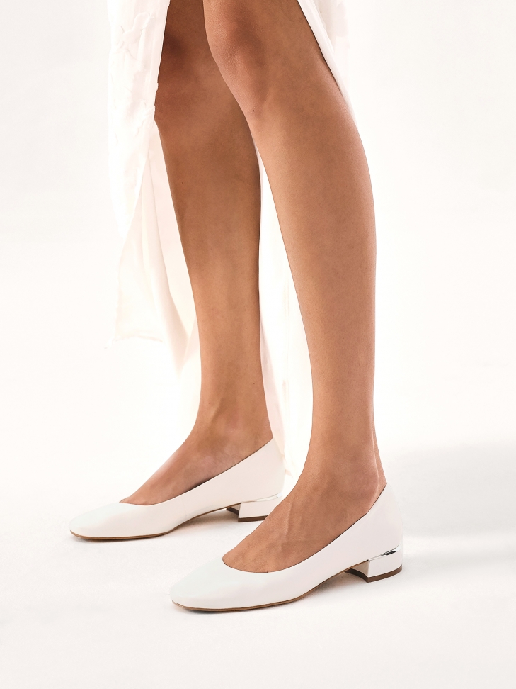 Flat white leather pumps