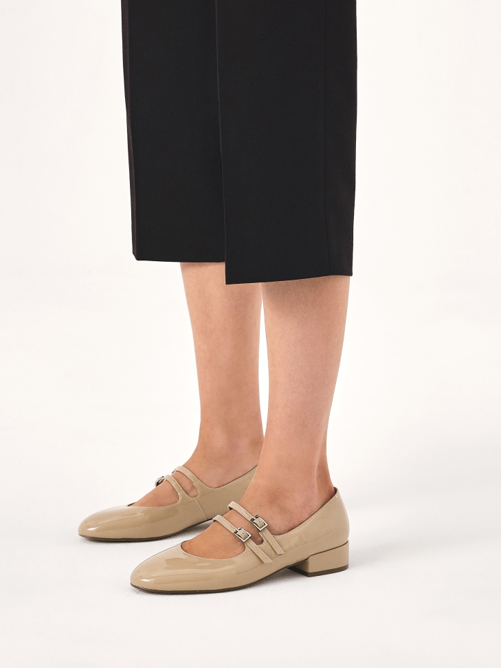 Beige patent leather Mary Jane style pumps