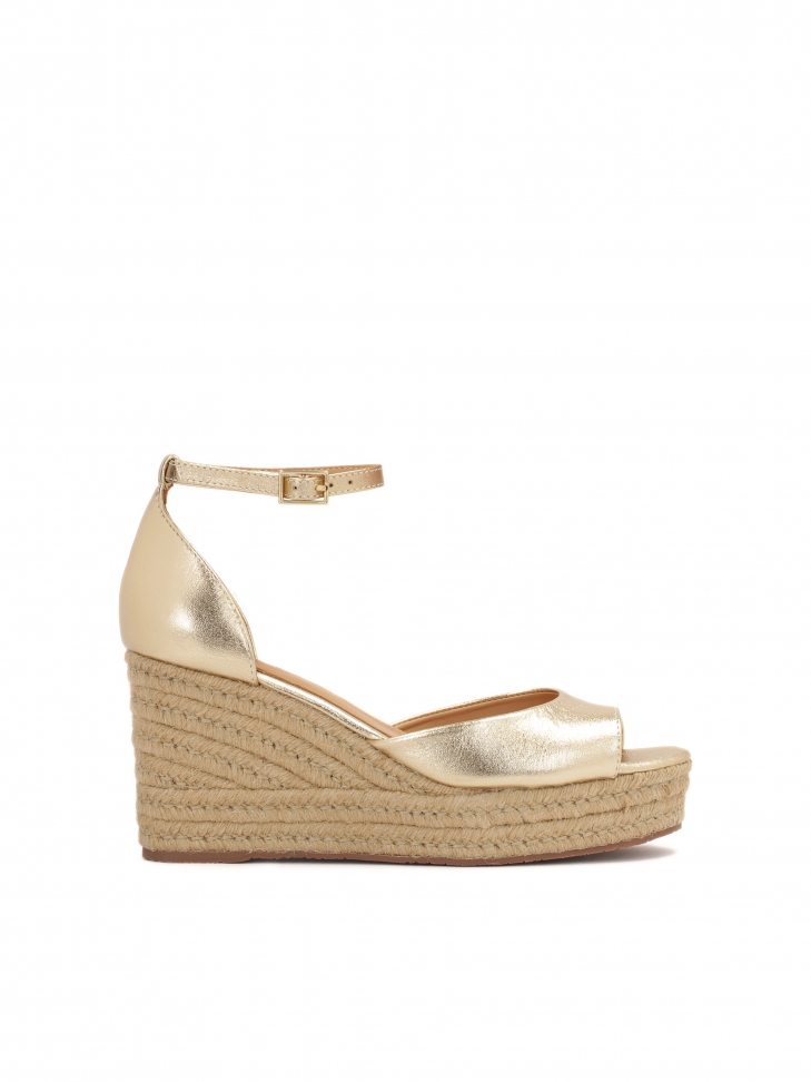 Gold sandals on anchor covered with jute cord