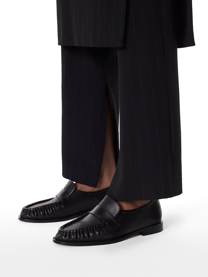 Black shoes with a striking crease on the front