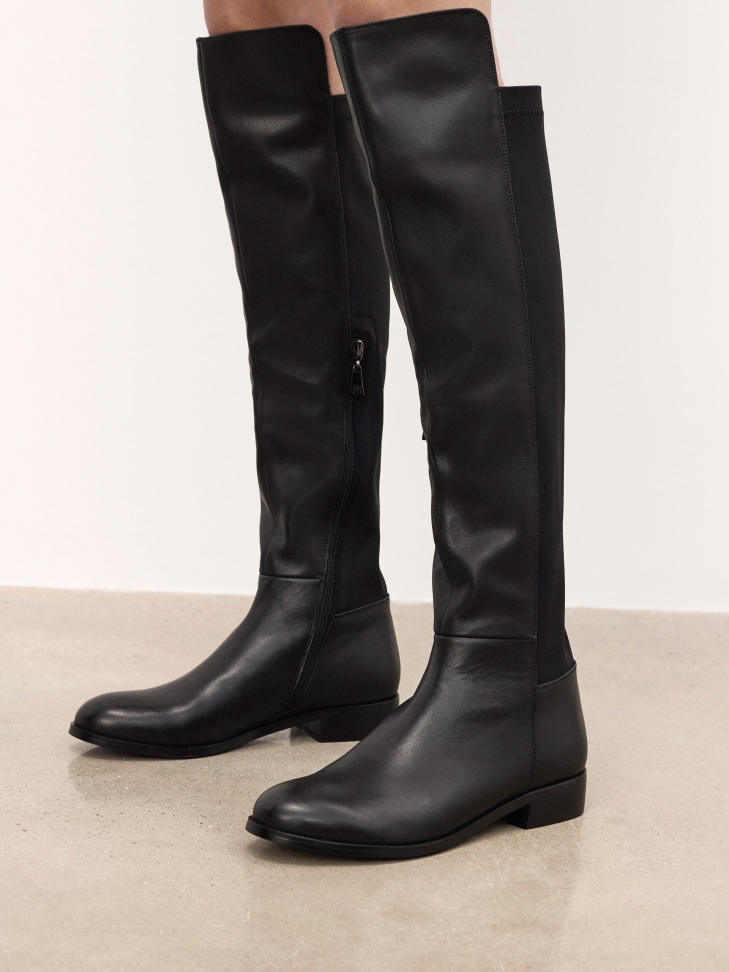 Black flat boots in leather and fabric