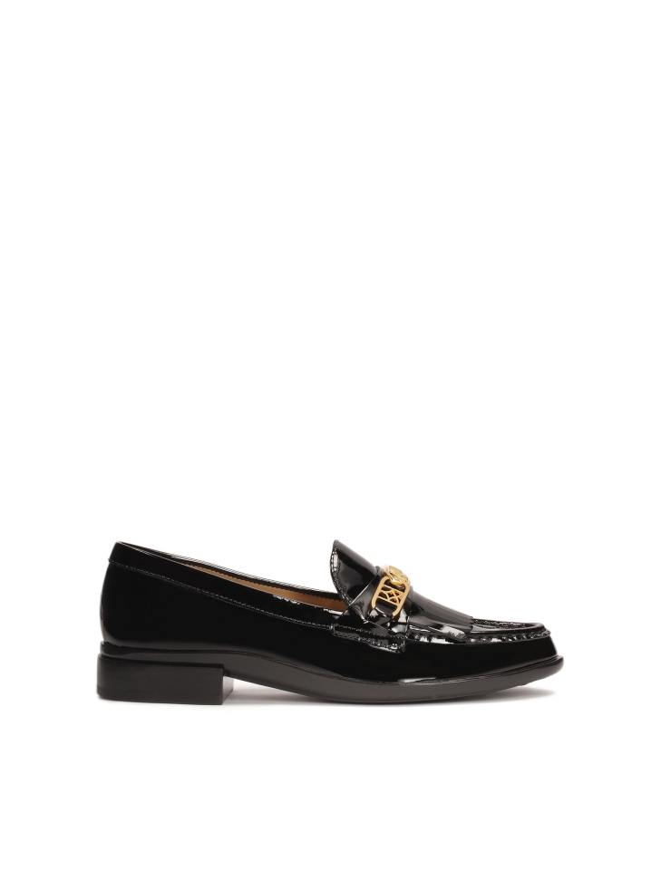Slip-on black loafers with metal embellishment and tassels