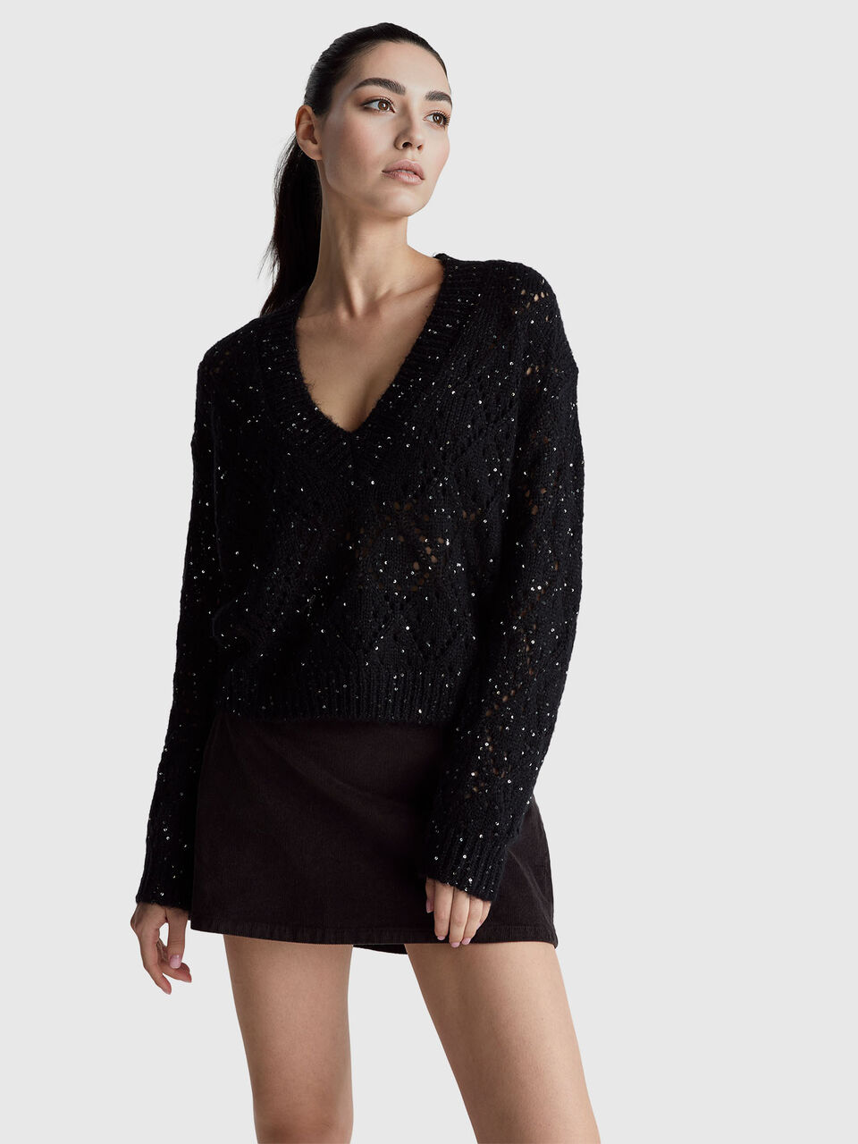 Perforated sweater with sequins