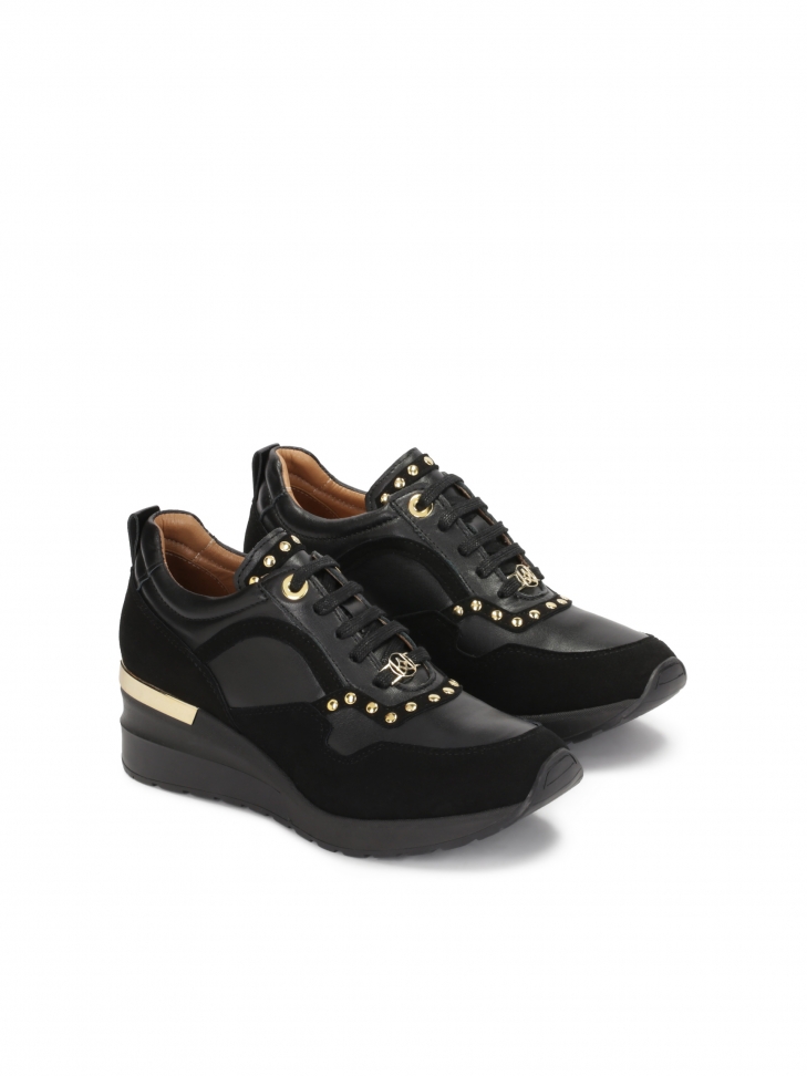 Black sneakers on an elevated sole