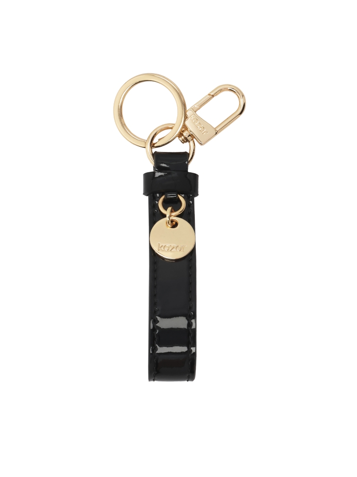Black patent leather key ring with gold accents and KAZAR logo