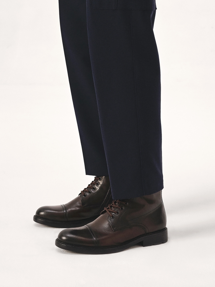 Brown boots with stitching on the nose