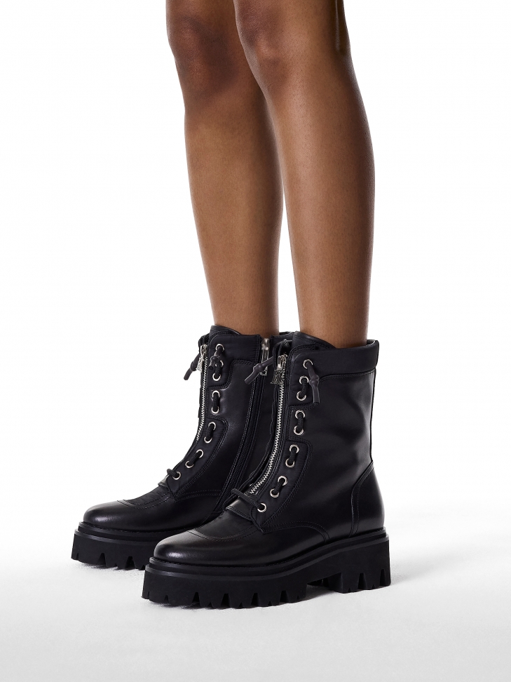 Black boots with a high upper on a trefoil sole
