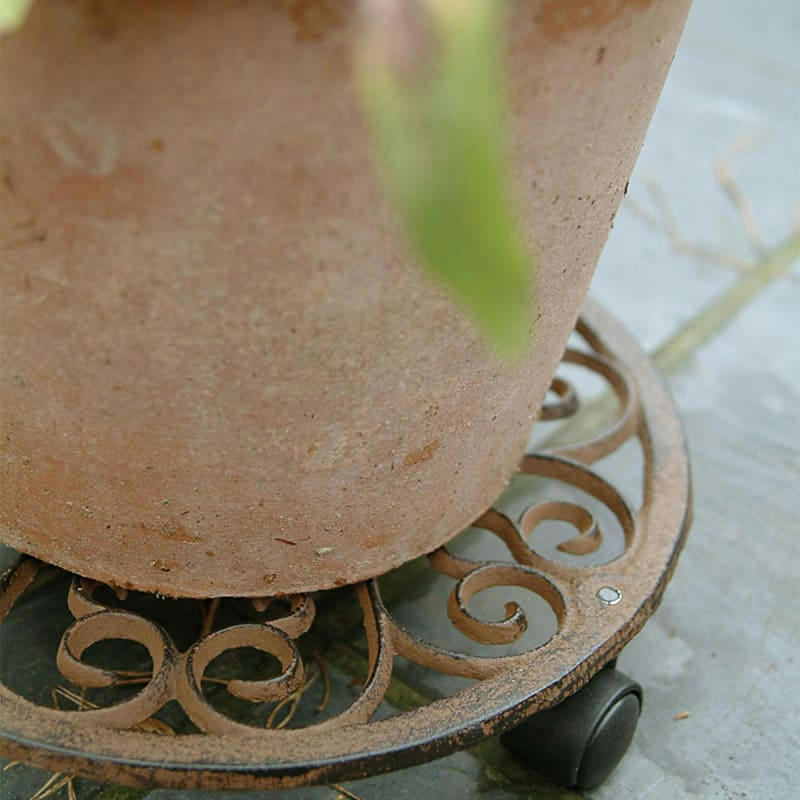 - Porte plante rond en fonte 4 roulettes