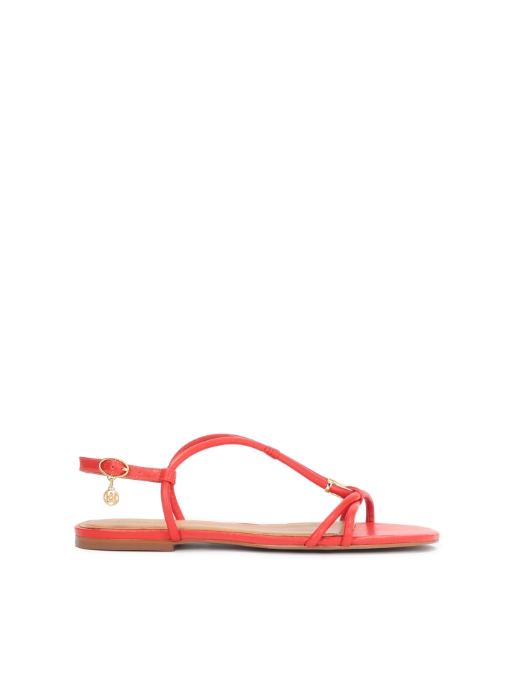Red sandals on a flat sole with an overhang