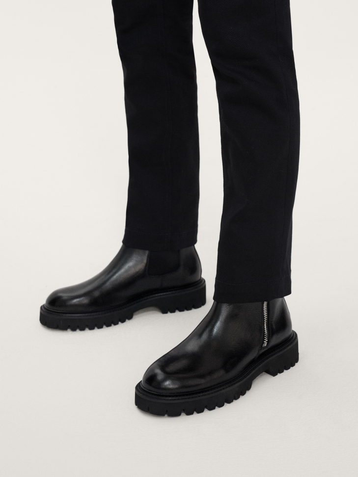 Men's leather flat ankle boots on a thick sole with a thread