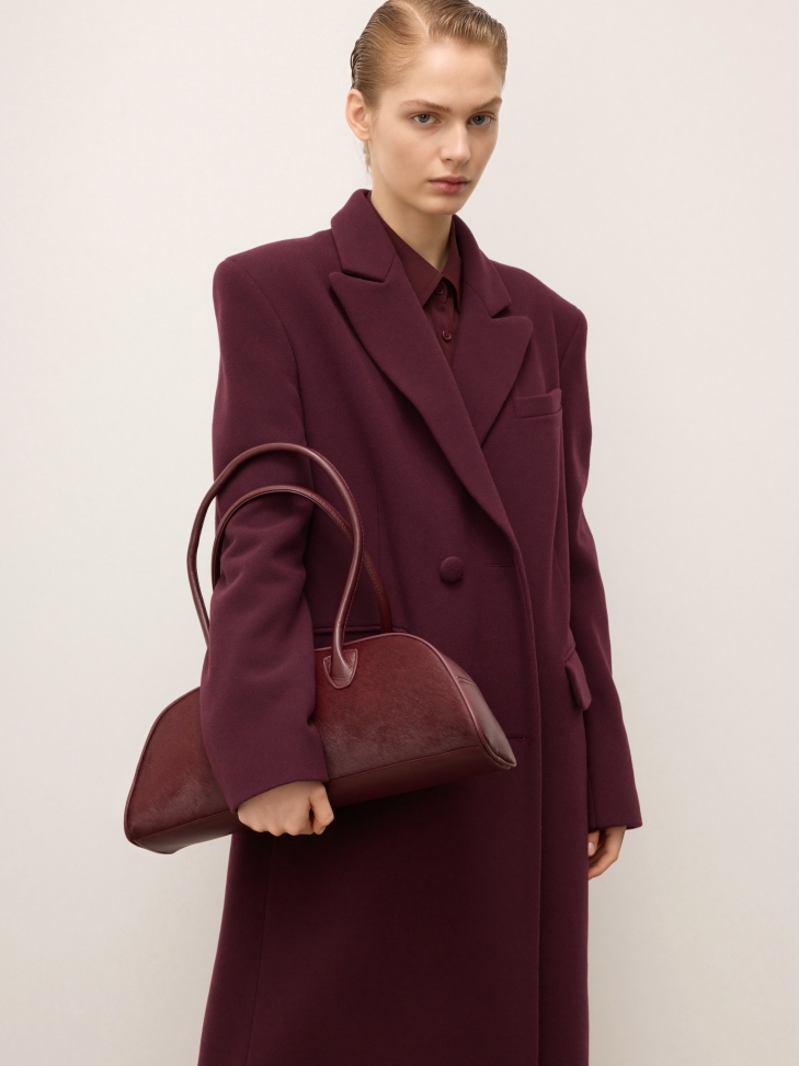 Maroon oblong shaped leather handbag with bristles