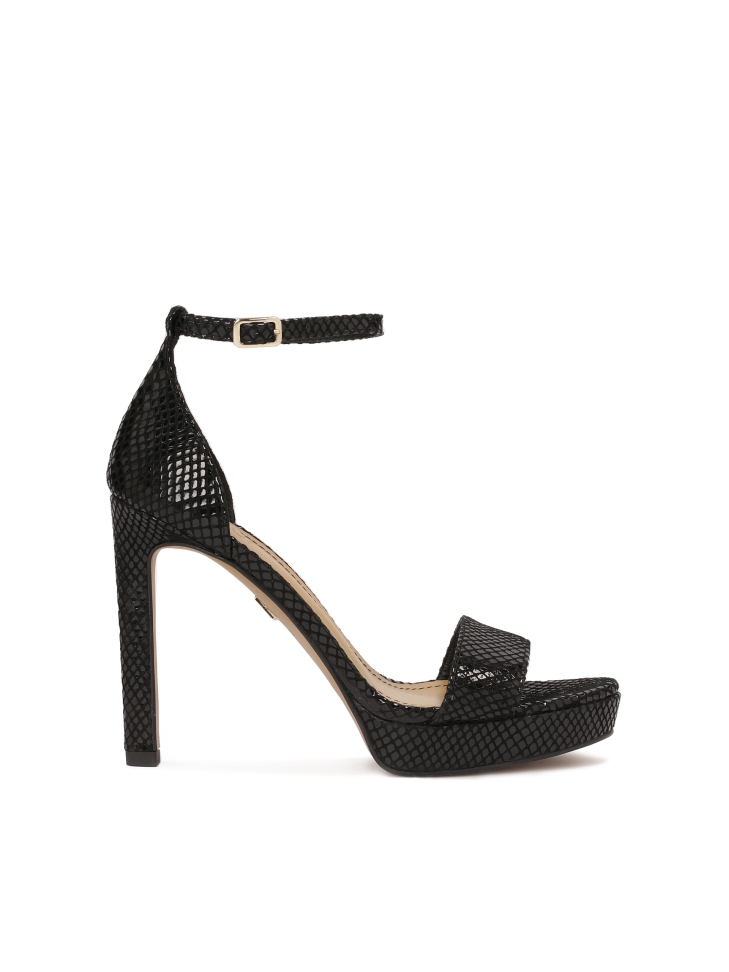 Black sandals on an embossed leather platform