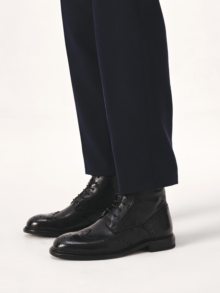 Black brogue decorated boots