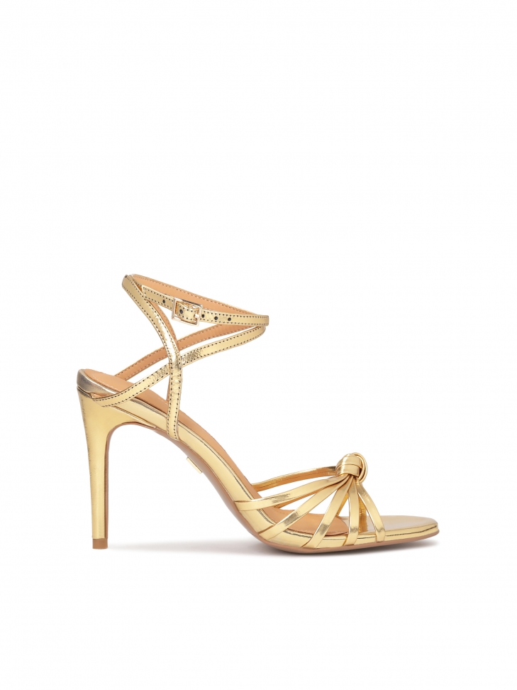 Elegant golden sandals with angled straps