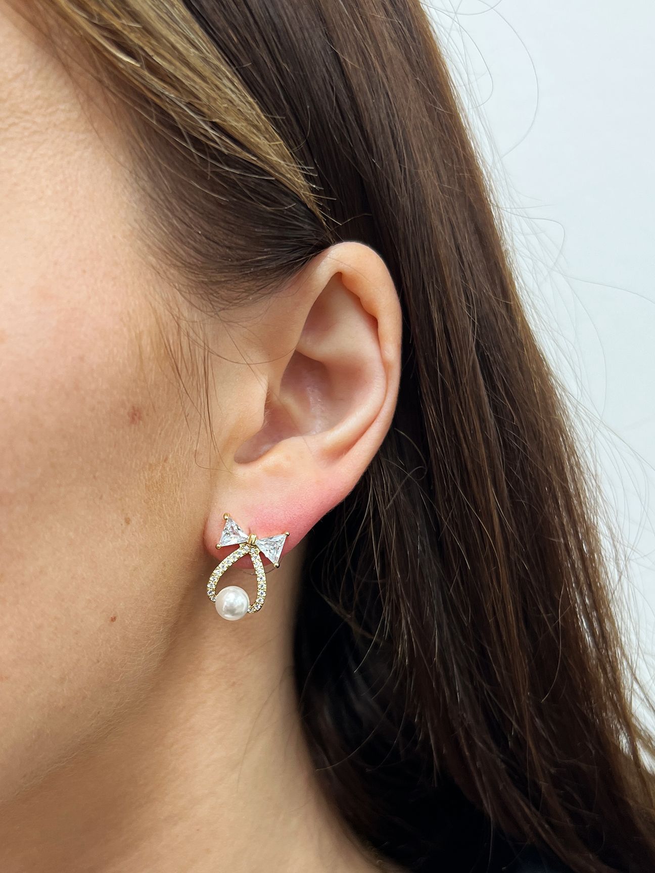 SVNX Studded Bow Earrings with Hanging Pearl in Gold - Gift Boxed