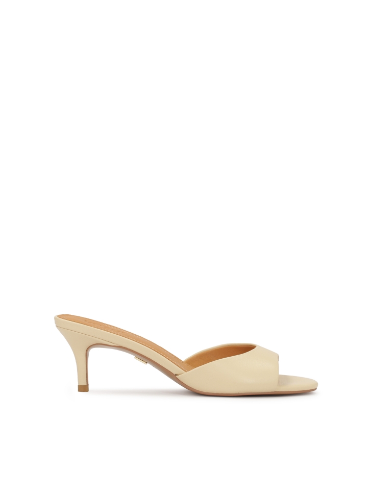 Cream mules on a low stiletto heel