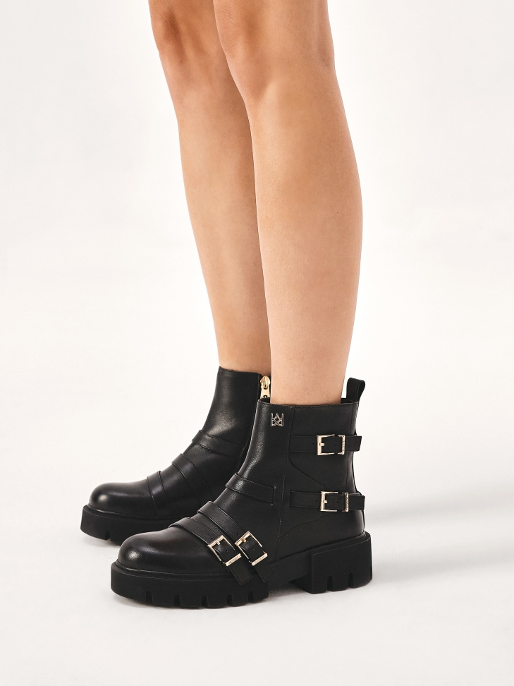 Flat boots decorated with straps with buckles