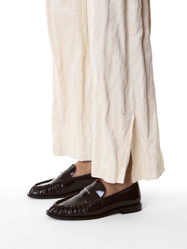 Dark brown shoes with a transverse stripe