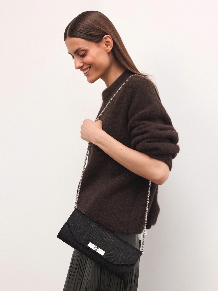 Elongated evening bag with bristles