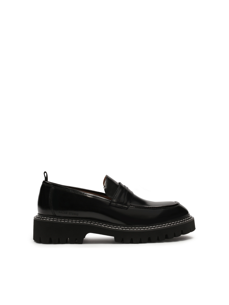 Black loafers stitched with white thread