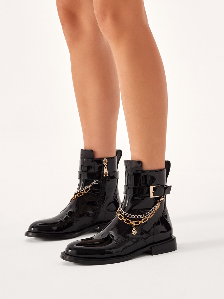 Patent leather boots decorated with chains