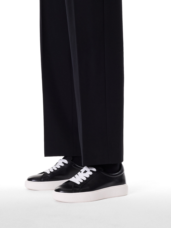 Black sneakers on contrasting sole