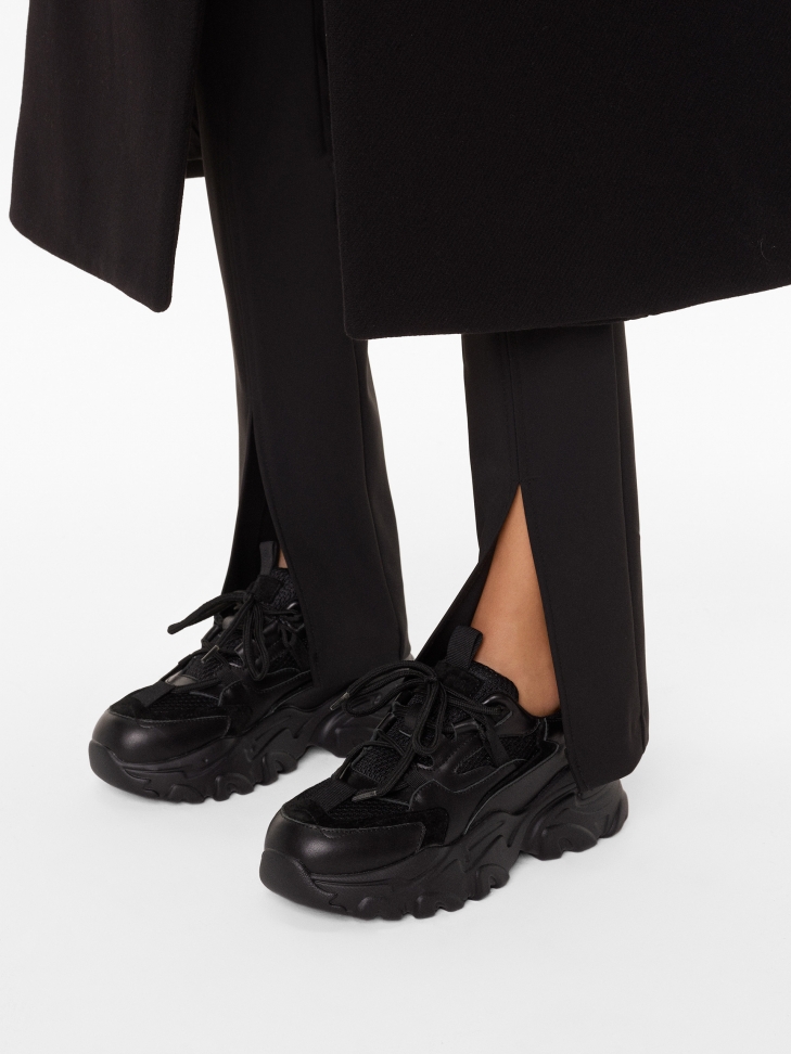 Ladies’ modern black leather sneakers on a thick sole