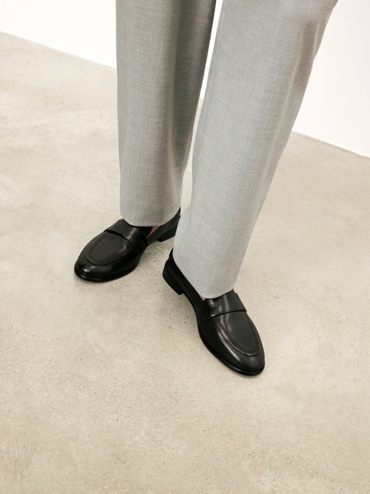 Black slip-on shoes with elastic at the heel