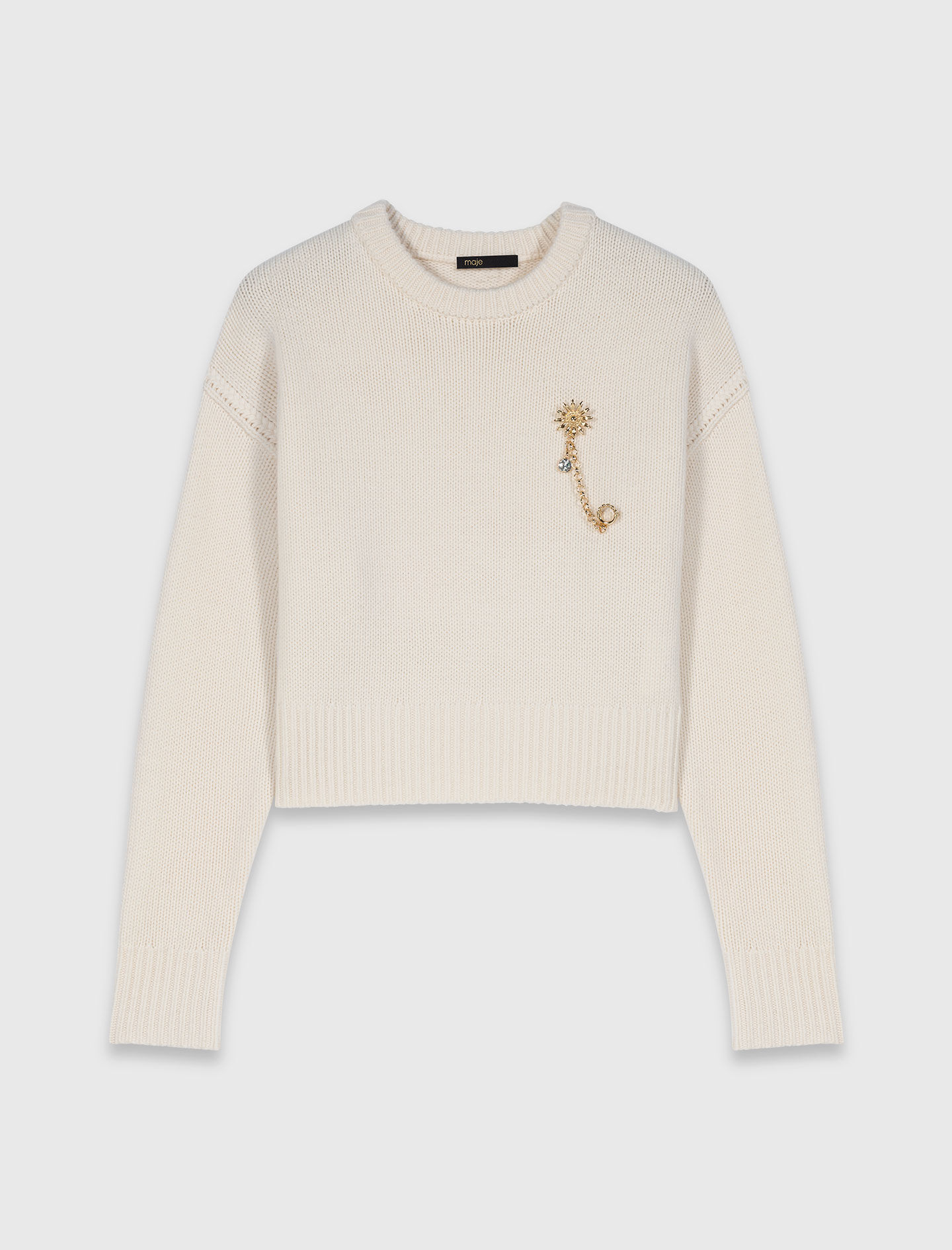 Pull avec broche florale
