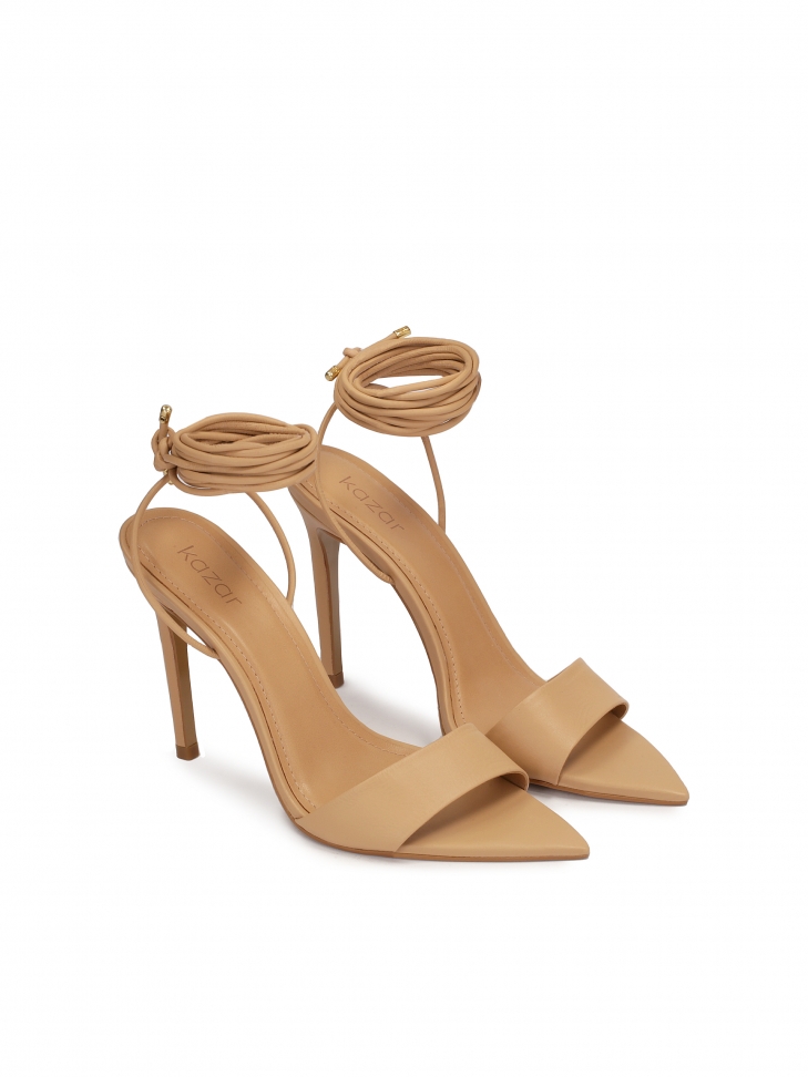 Spiky leather sandals laced around the ankle