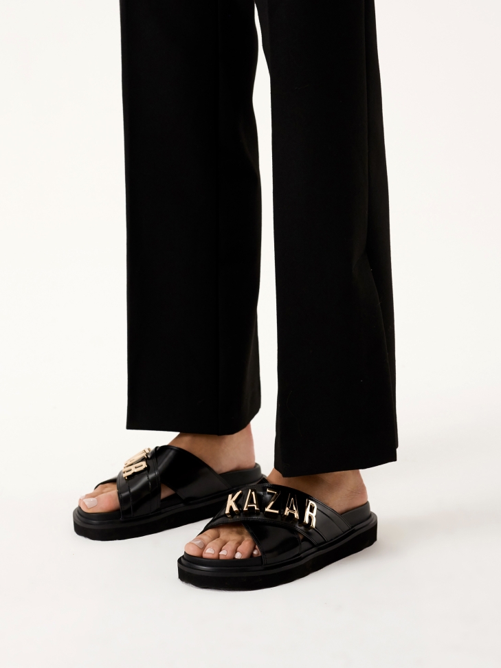 Black leather mules with metal lettering