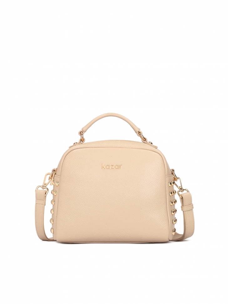 Handbag in leather decorated with rivets