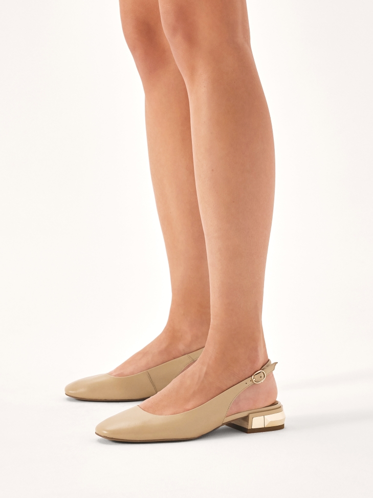 Beige pumps with metal embellishment on the heel