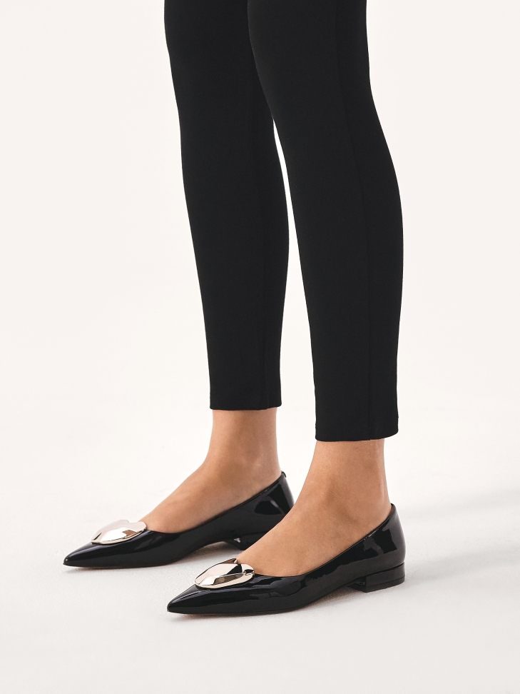 Black patent leather pumps on a flat sole