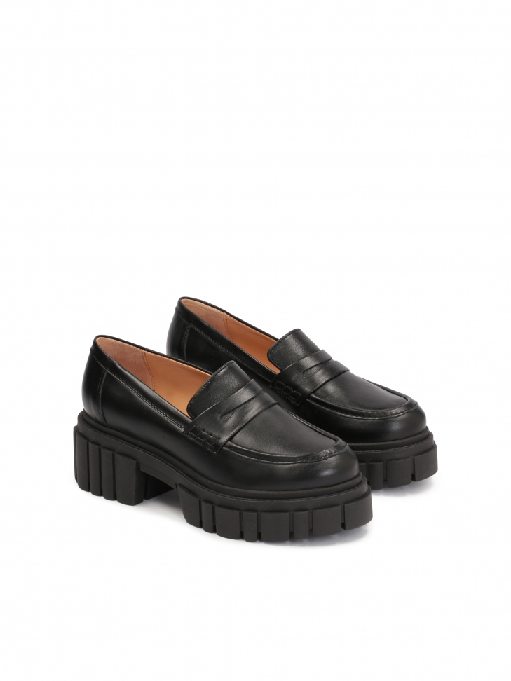 Black leather women's shoes on a thick corrugated sole