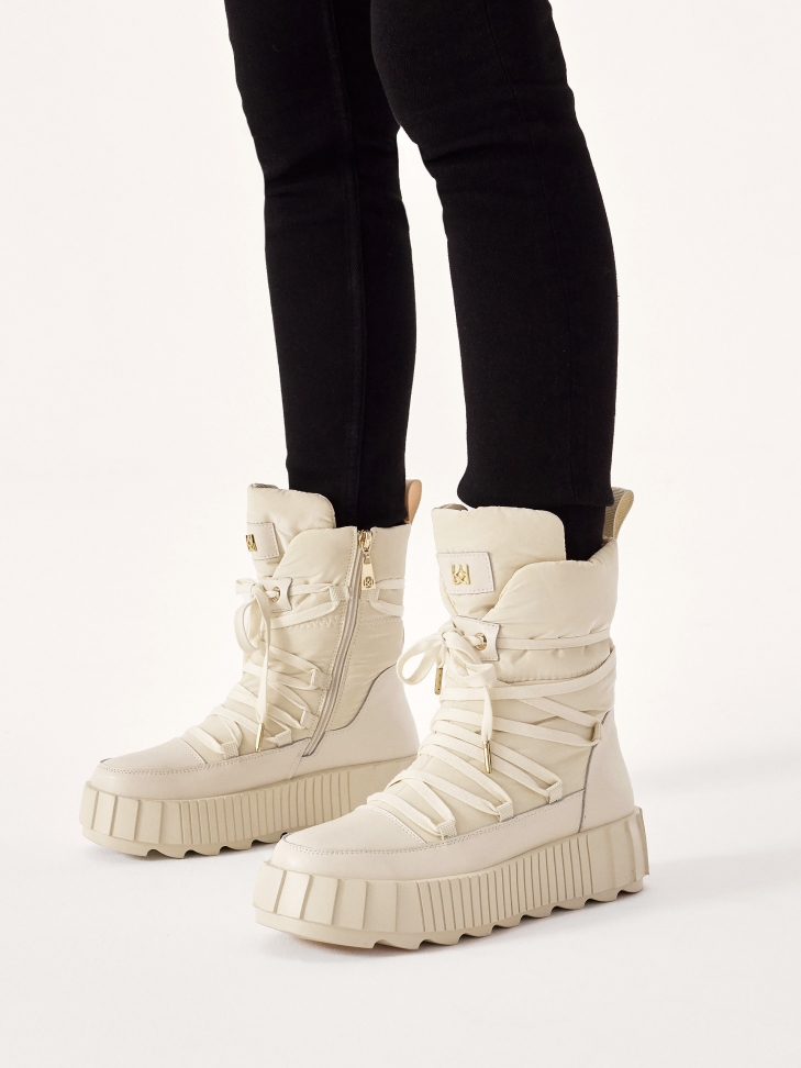 Fashionable snow boots in beige color