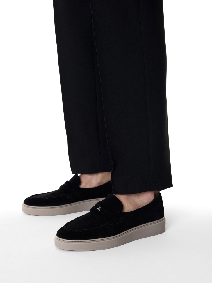 Black slip-on sneakers with silver logo