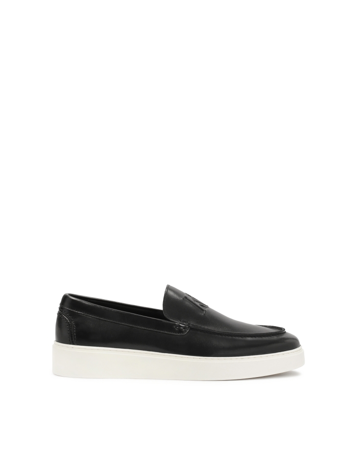 Black slip-on sneakers with white sole