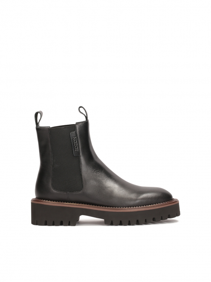 Black Chelsea boots with brown piping on the sole
