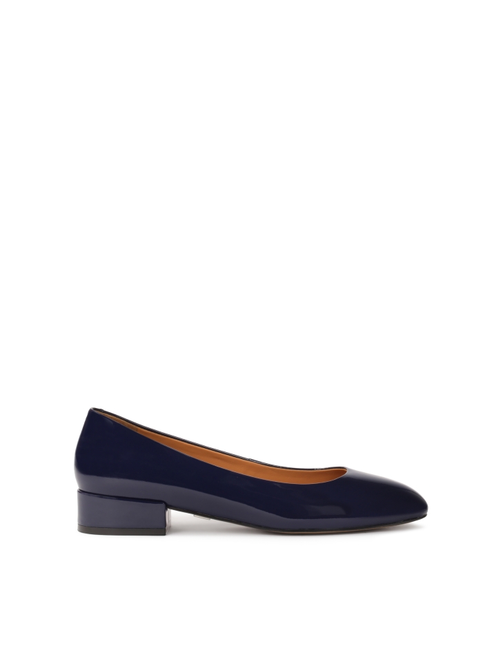 Navy blue patent leather pumps on a post