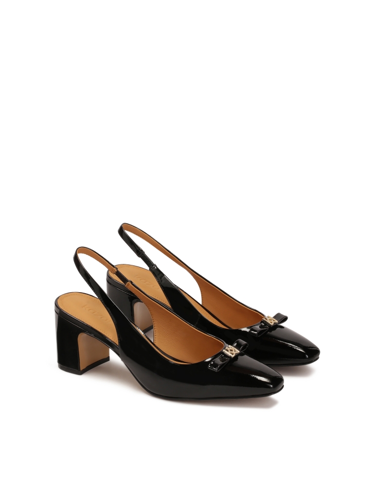 Black patent leather pumps with embellishment on the nose