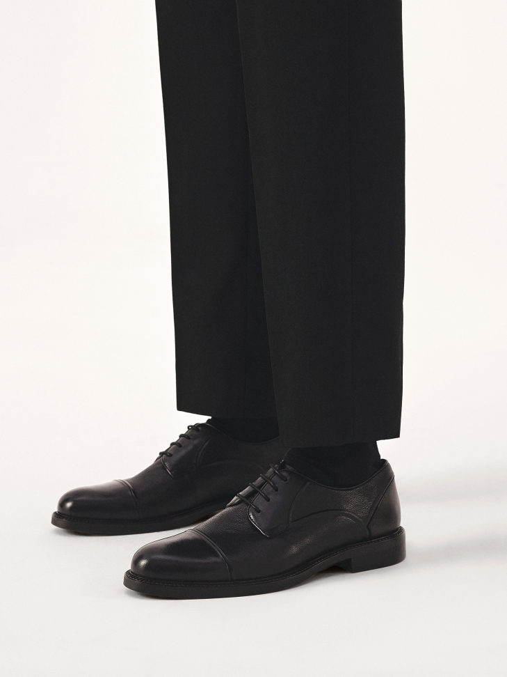 Black leather shoes with stitching
