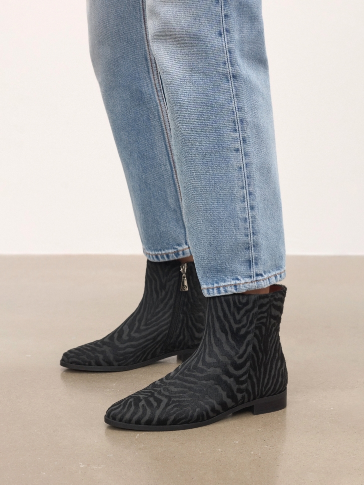 Patterned leather boots with natural hair finish